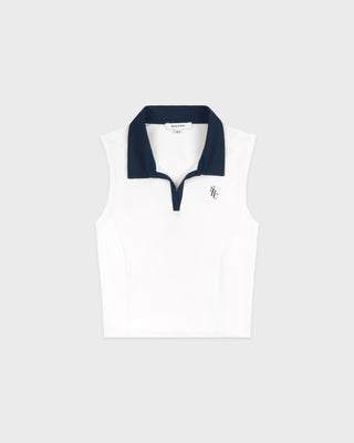 White sleeveless polo shirt with navy collar on a white background