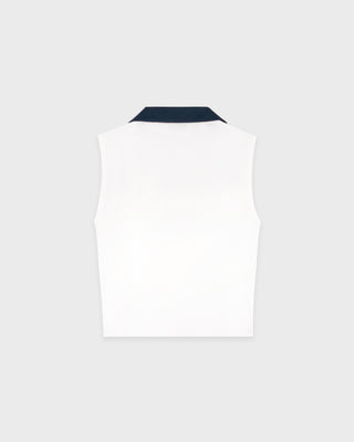 White sleeveless top with a dark collar on a light gray background