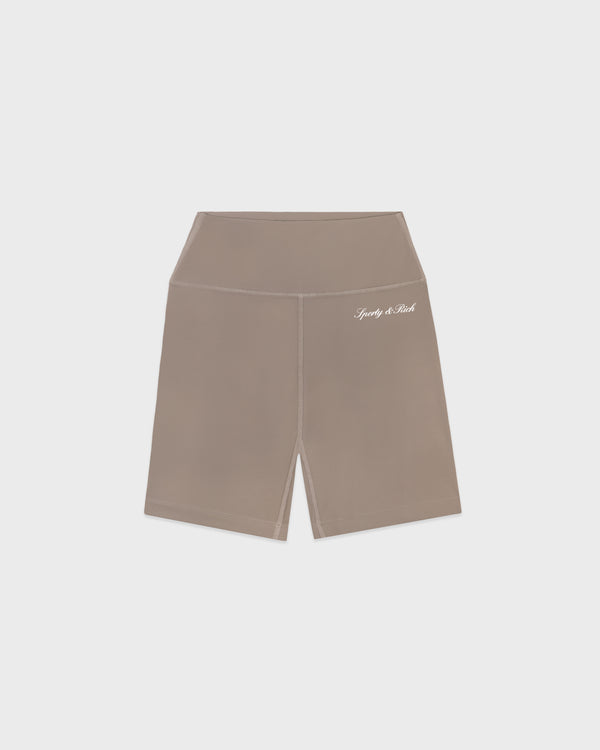The Signature Logo Biker Short in Hazelnut/White is a high-waisted bike short crafted from a comfortable nylon-spandex blend and features a small white printed "lovely & real" logo on the left hip, set against a white background.