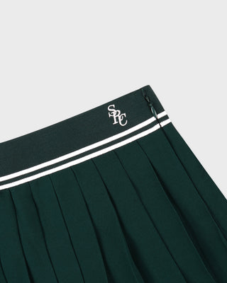 Green pleated skirt with a logo on the waistband against a light gray background