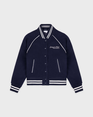 Navy blue varsity jacket with white accents on a light gray background