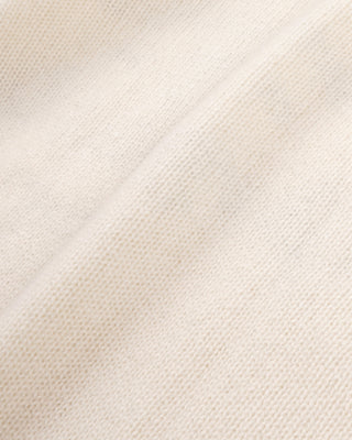 Close-up of a textured beige fabric with a subtle pattern