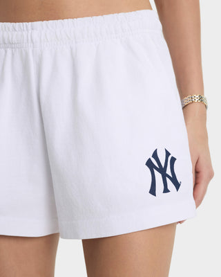 White shorts with a navy blue logo on a white background