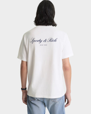Person wearing a white t-shirt with 'Sporty & Rich' logo on the back, standing against a plain background.