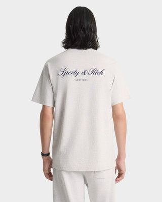 Person wearing a white t-shirt with 'Sporty & Rich' logo on the back, standing against a plain background.