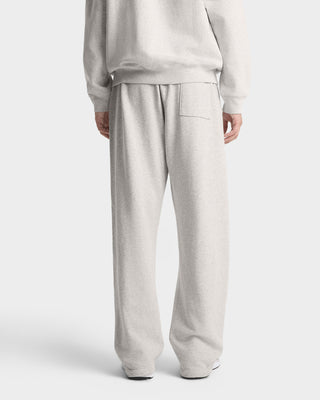 Person wearing light gray sweatpants and a matching sweatshirt on a white background
