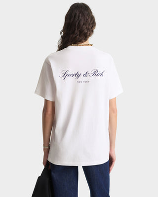 Person wearing a white t-shirt with 'Sporty & Rich' logo on the back, standing against a plain background.