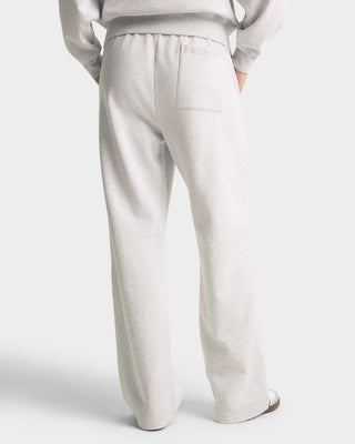 Light gray pants worn by a person on a white background