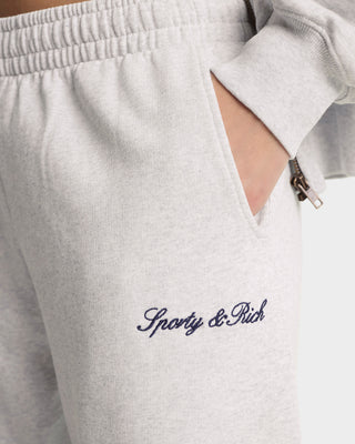 Gray sweatpants with 'Sporty & Rich' embroidery on a white background