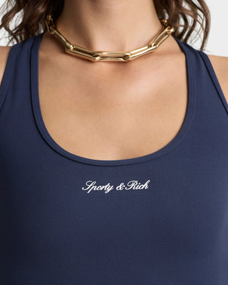 Navy tank top with 'Sporty & Rich' logo and gold necklace on a neutral background
