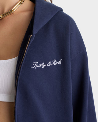 Navy blue jacket with 'Sporty & Rich' logo on a white background