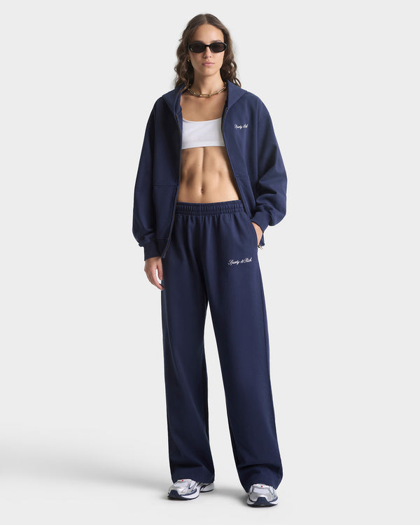 Woman wearing a navy tracksuit with 'Bacca Bucci' branding on a white background