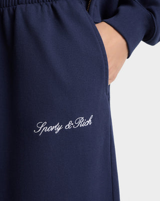 Navy blue sweatpants with 'Sporty & Rich' embroidery on a white background