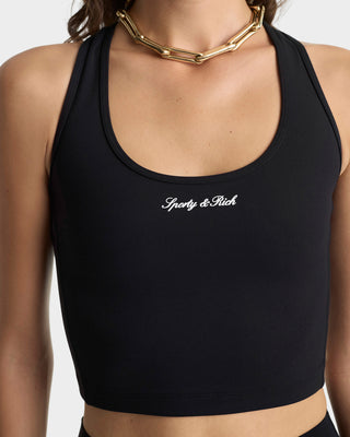 Black sports bra with 'Sporty & Rich' branding on a neutral background