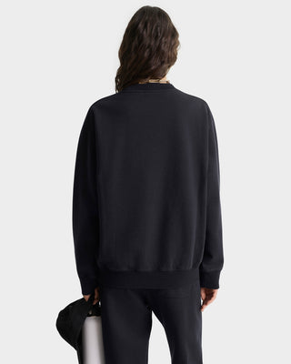 Person wearing a black sweatshirt and pants on a white background