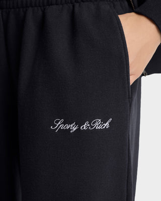 Black sweatpants with 'Sporty & Rich' embroidery on a white background