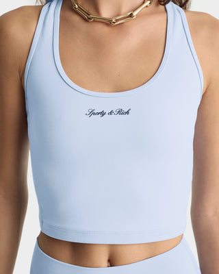 Light blue sports bra with 'Sporty & Rich' branding on a white background