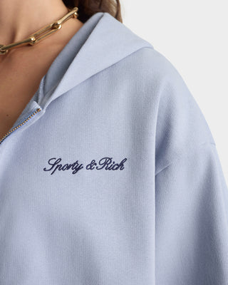 Light blue sweatshirt with 'Sporty & Rich' embroidery on a white background