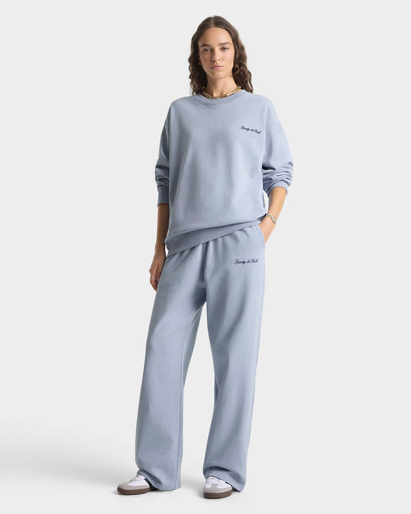 Person wearing a light blue sweatshirt and pants set with text on a white background