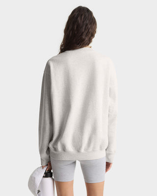 Person wearing a light gray sweatshirt and shorts on a white background