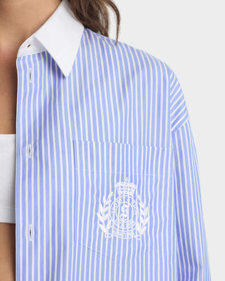 Blue and white striped shirt with a logo on a plain background