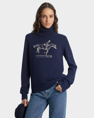 Woman wearing a navy sweater with a horse graphic on a white background