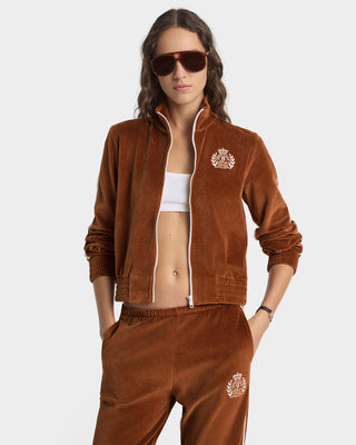 Woman wearing a brown tracksuit with a logo on a white background