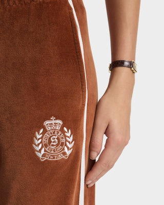 Brown sweatpants with a white logo on a white background