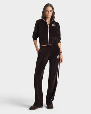 Person wearing a black tracksuit with a brand logo on a white background