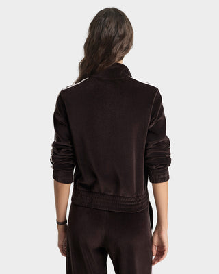 Person wearing a brown tracksuit on a white background