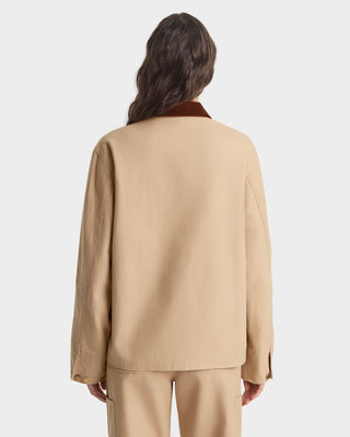 Person wearing a beige suit on a white background