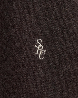 Small logo on a textured black surface