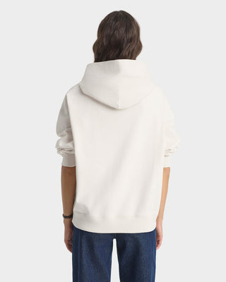 Person wearing a white hoodie on a plain background