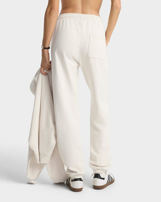 Person wearing white wide-leg pants on a plain background