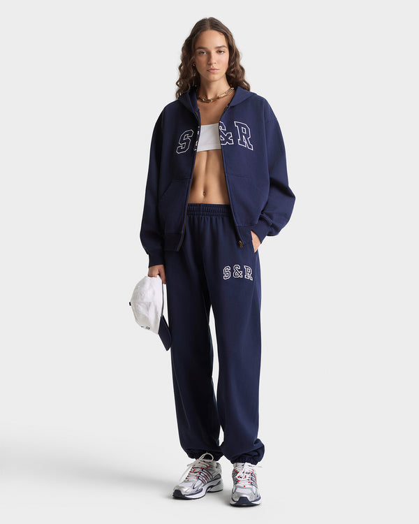 Person wearing a navy tracksuit with 'SBR' branding on a white background