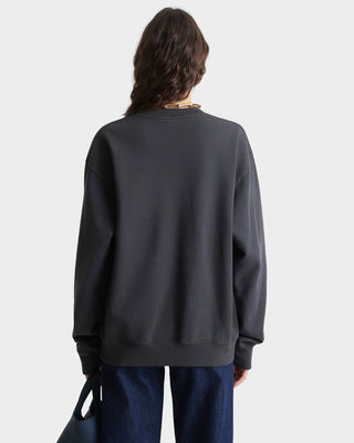 Person wearing a dark gray sweatshirt on a light gray background