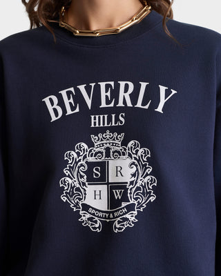 Navy blue sweatshirt with 'Beverly Hills' and crest design on a plain background
