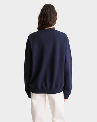 Person wearing a navy blue sweater on a white background