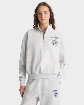 Person wearing a gray tracksuit with 'Beverly' branding on a white background