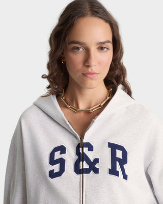 Person wearing a gray hoodie with 'S & R' on a white background