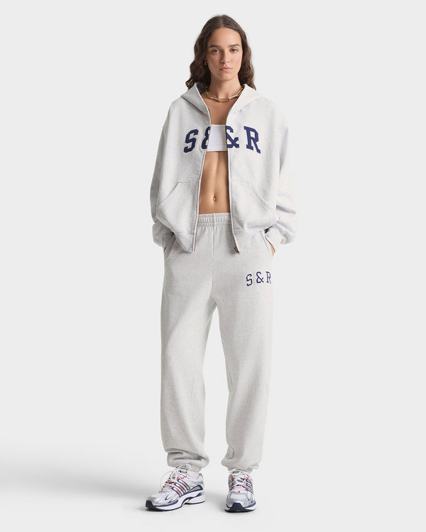 Person wearing a gray tracksuit with 'S & R' branding on a white background