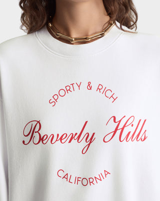 White sweatshirt with 'Sporty & Rich Beverly Hills California' text on a white background
