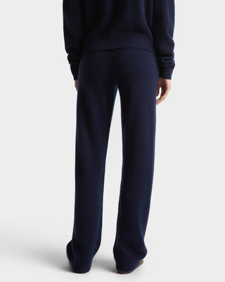 Navy blue sweater and pants set on a white background