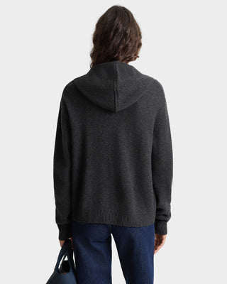 Person wearing a dark gray hoodie from behind on a white background