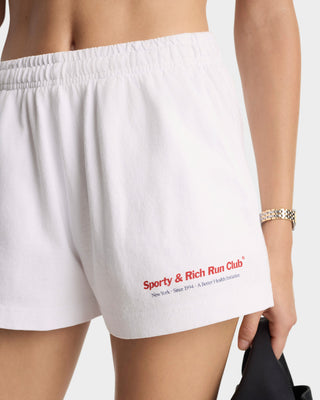 White shorts with 'Sporty & Rich Run Club' text on a plain background