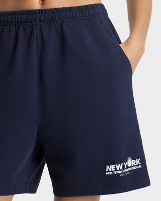 Navy blue shorts with 'New York Pro Tennis Invitational' logo on a white background