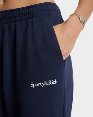 Navy sweatpants with 'Sporty&Rich' logo on a white background