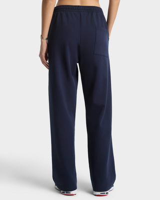 Navy blue pants worn by a person on a white background