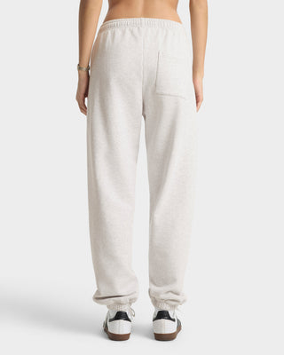 White sweatpants worn by a person on a white background