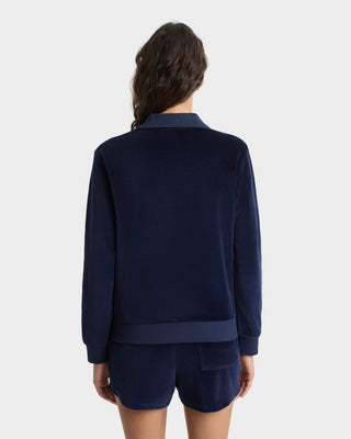 Person wearing a navy blue tracksuit on a white background